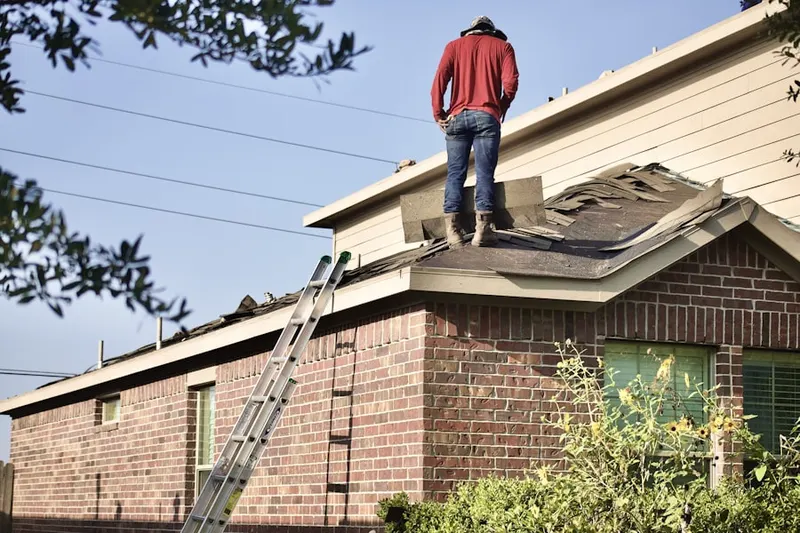 Professional roofer working on a residential roof in Downtown Riverfront